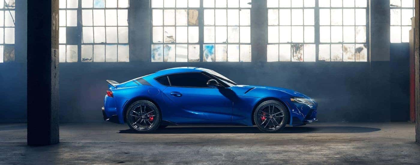 Blue 2022 Toyota Supra GR parked in a garage from the side
