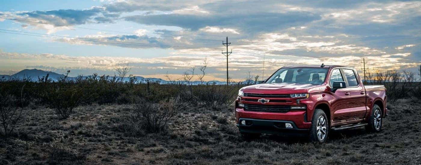 Red 2023 Chevy Silverado 1500 RTS parked off-road after seeing a used truck