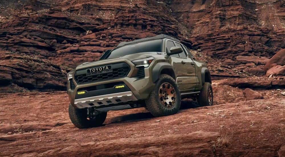 Green 2024 Toyota Tacoma TRD Off-Road parked in a desert