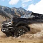 Black 2025 Ford Bronco drifting off-road