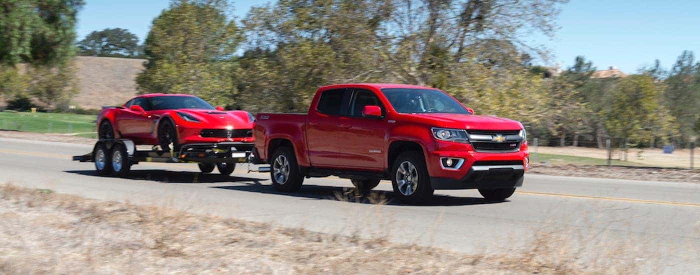 Red 2018 Chevy Colorado Z71 towing a Corvette to look at used diesel trucks near Durham, NC