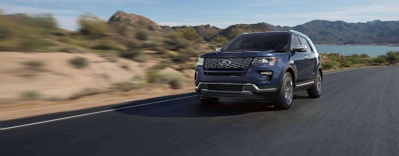 Blue 2021 Ford Explorer XLT is shown from the front at an angle after leaving a dealer that has used SUVs for sale near Mebane.