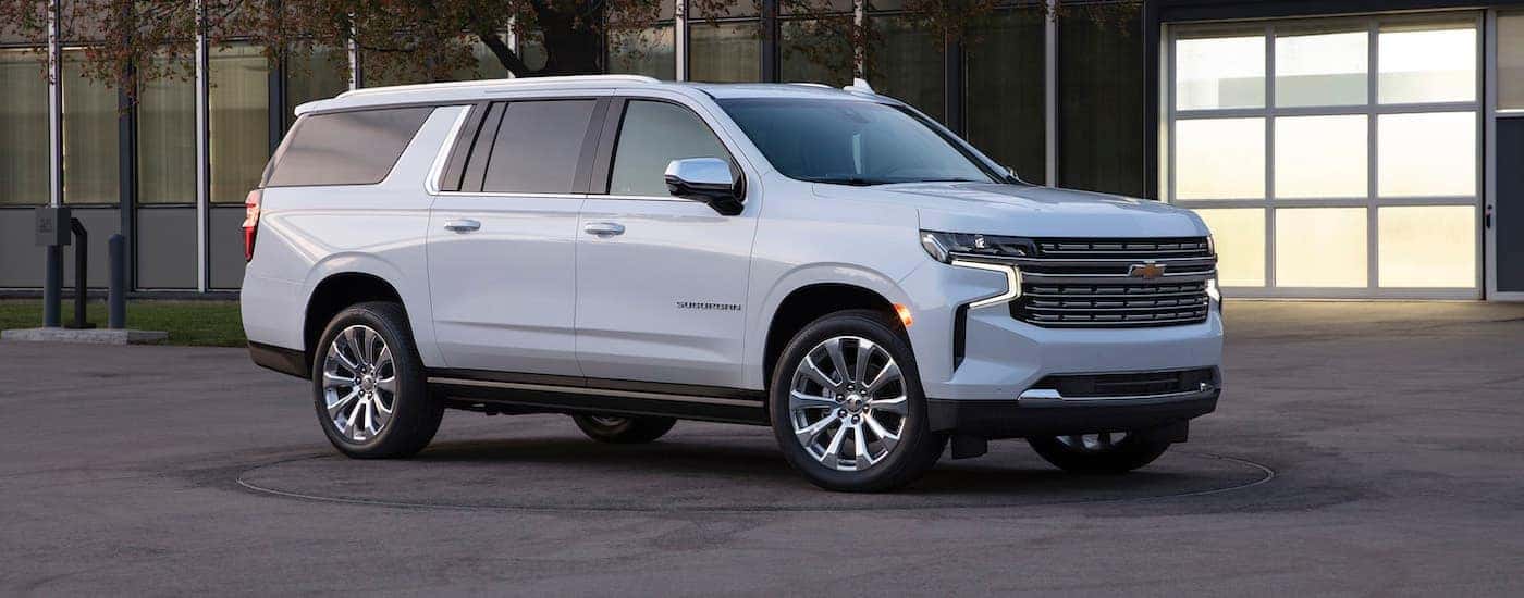 A white 2021 Chevy Suburban parked in front of a building