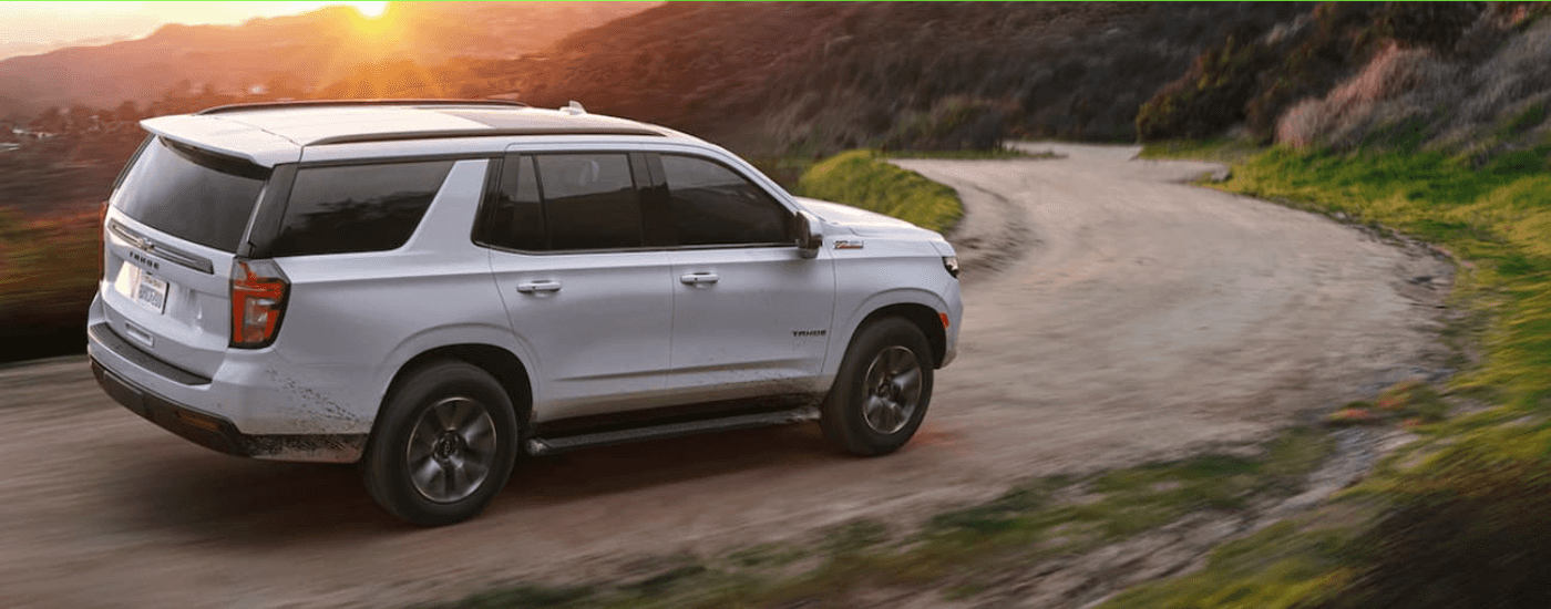 A white 2021 Chevy Tahoe is shown from the side after leaving a dealer near that has used SUVs near Cary, NC.