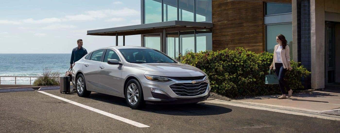 A silver 2023 Chevy Malibu is shown parked after viewing used cars for sale near Burlington.