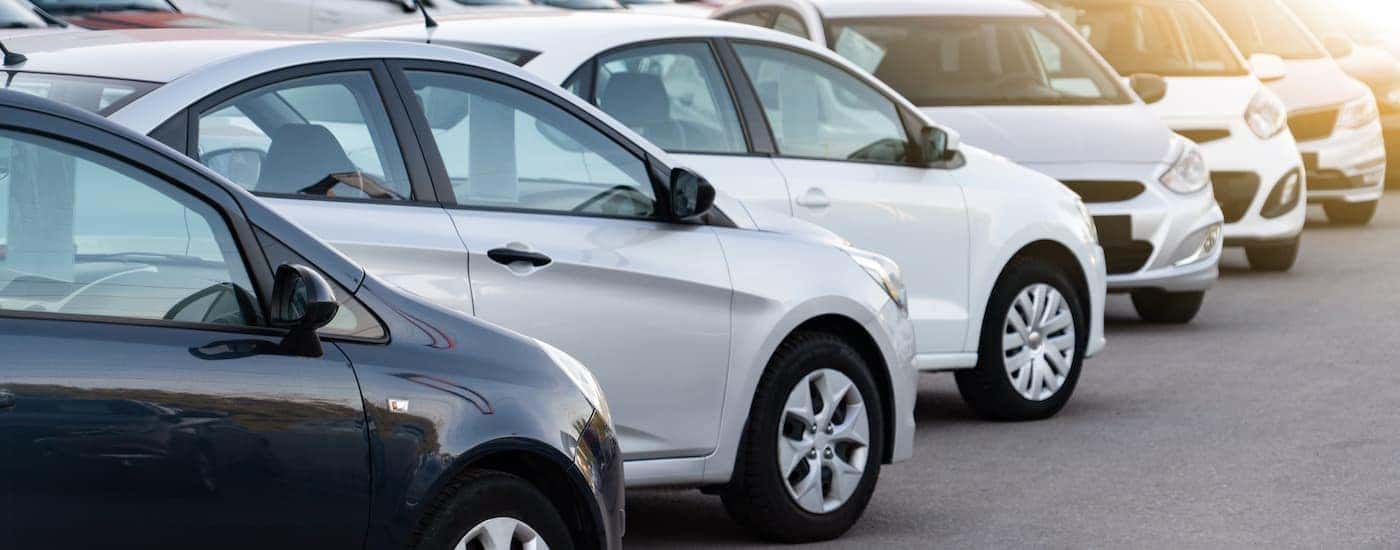 Two rows of used cars for sale in Durham, NC, are shown.
