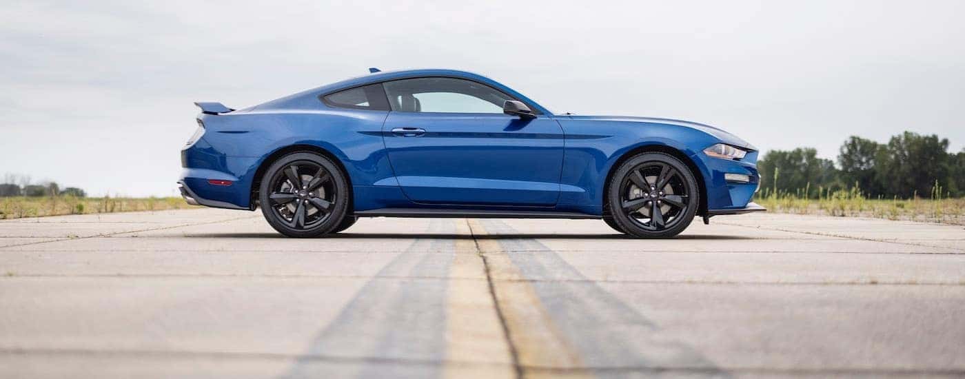 A blue 2022 Ford Mustang from the side after leaving a dealer that has a used Ford for sale.
