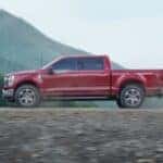 A red 2023 Ford F-150 parked off-road.