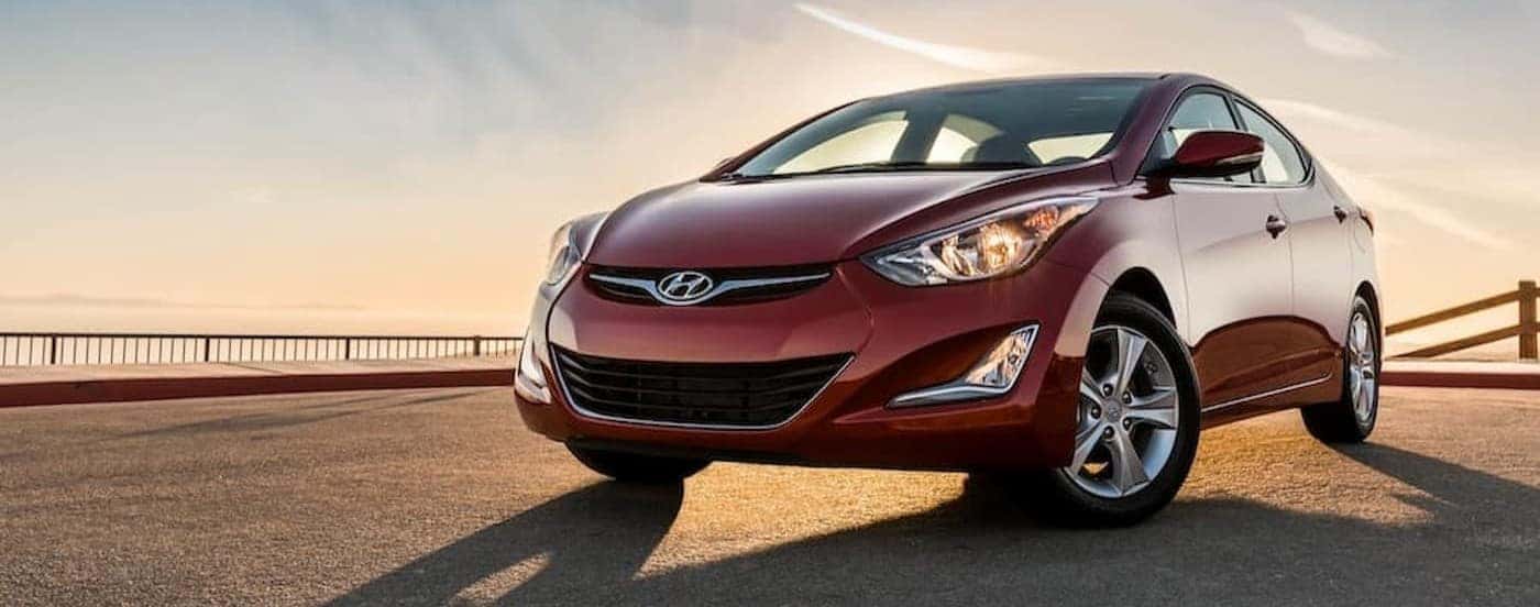 A red 2016 Hyundai Elantra parked after viewing used cars for sale under 20k.