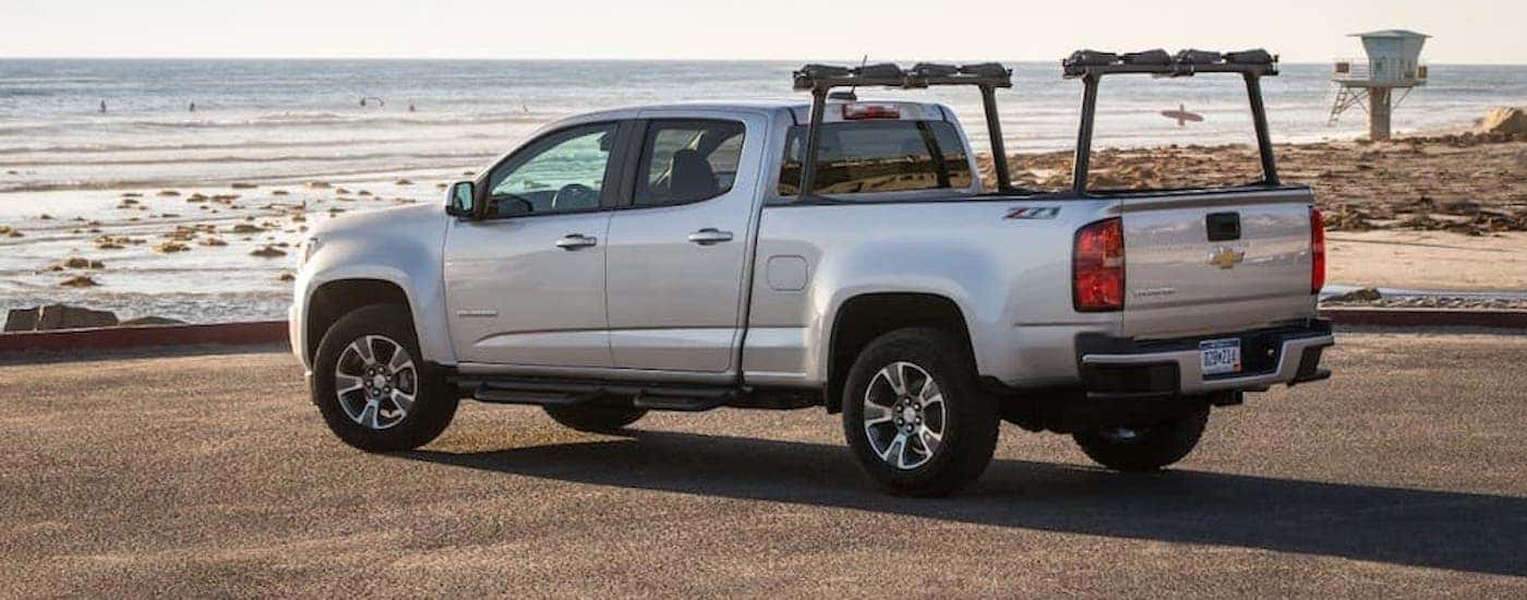 A silver 2016 Chevy Colorado parked on a beach.