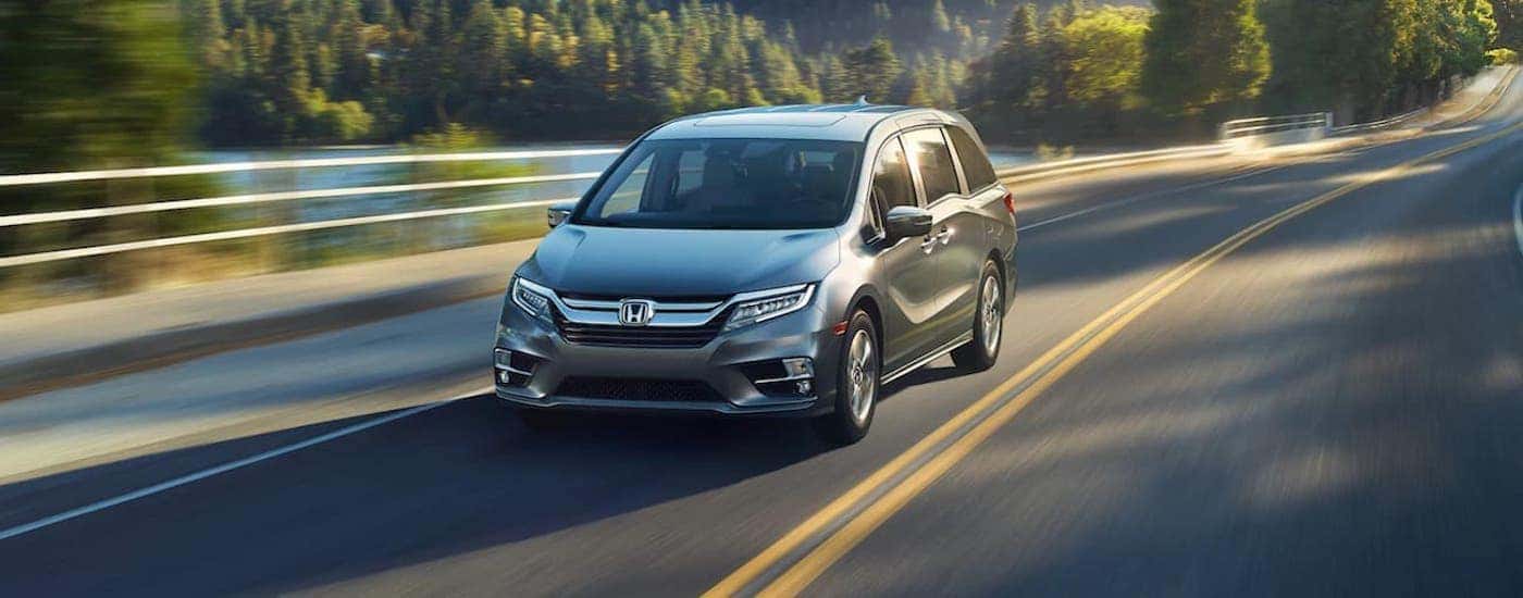 A silver 2020 Honda Odyssey driving on a highway.