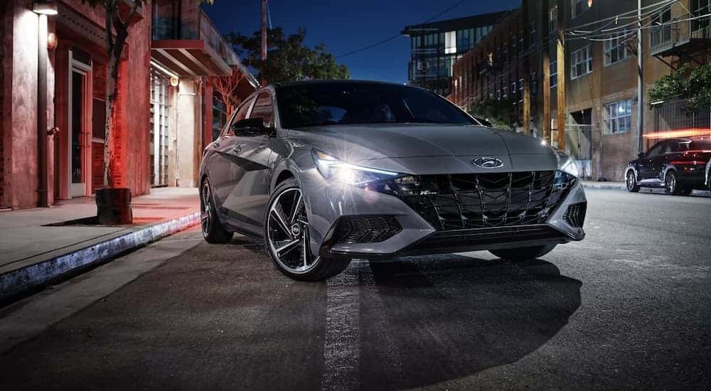A gray 2023 Hyundai Elantra parked in a city.