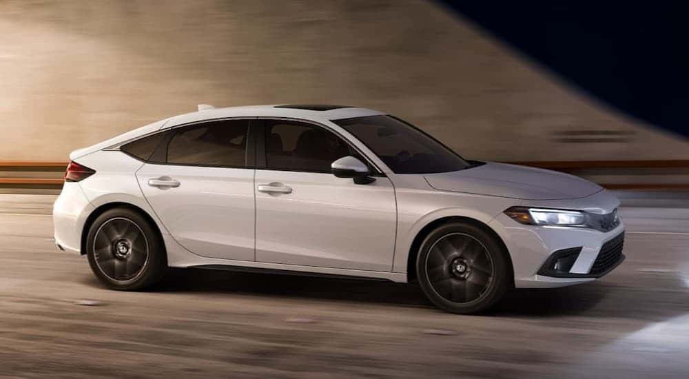 A white 2024 Honda Civic driving in a tunnel.