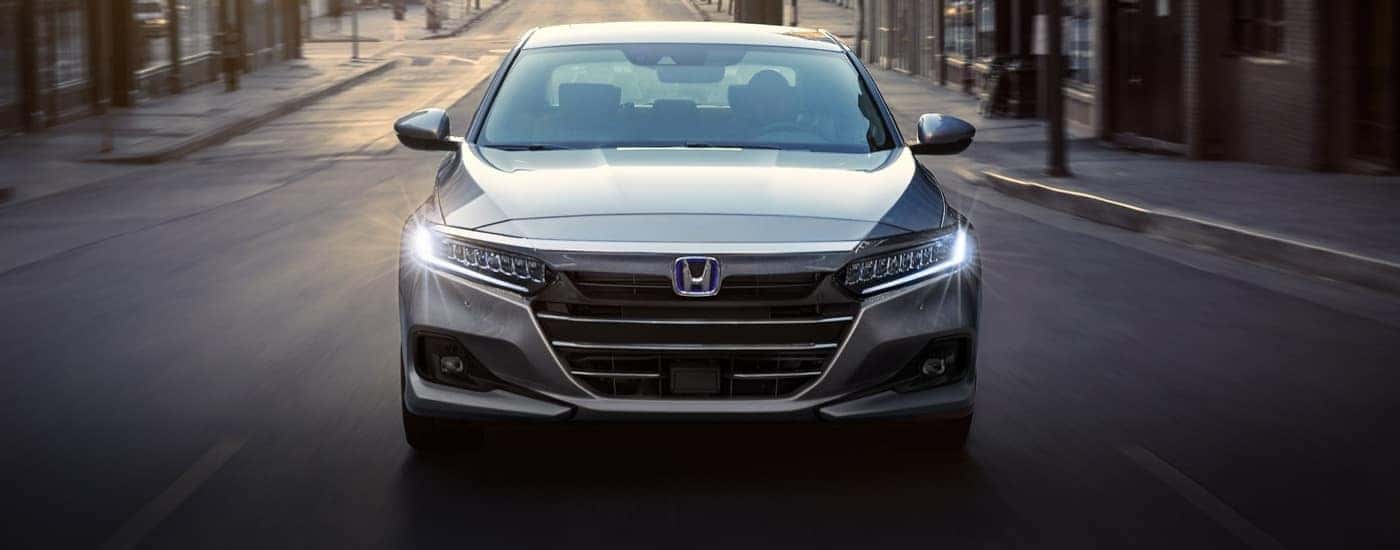 A gray 2022 Honda Accord Hybrid shown head-on driving.