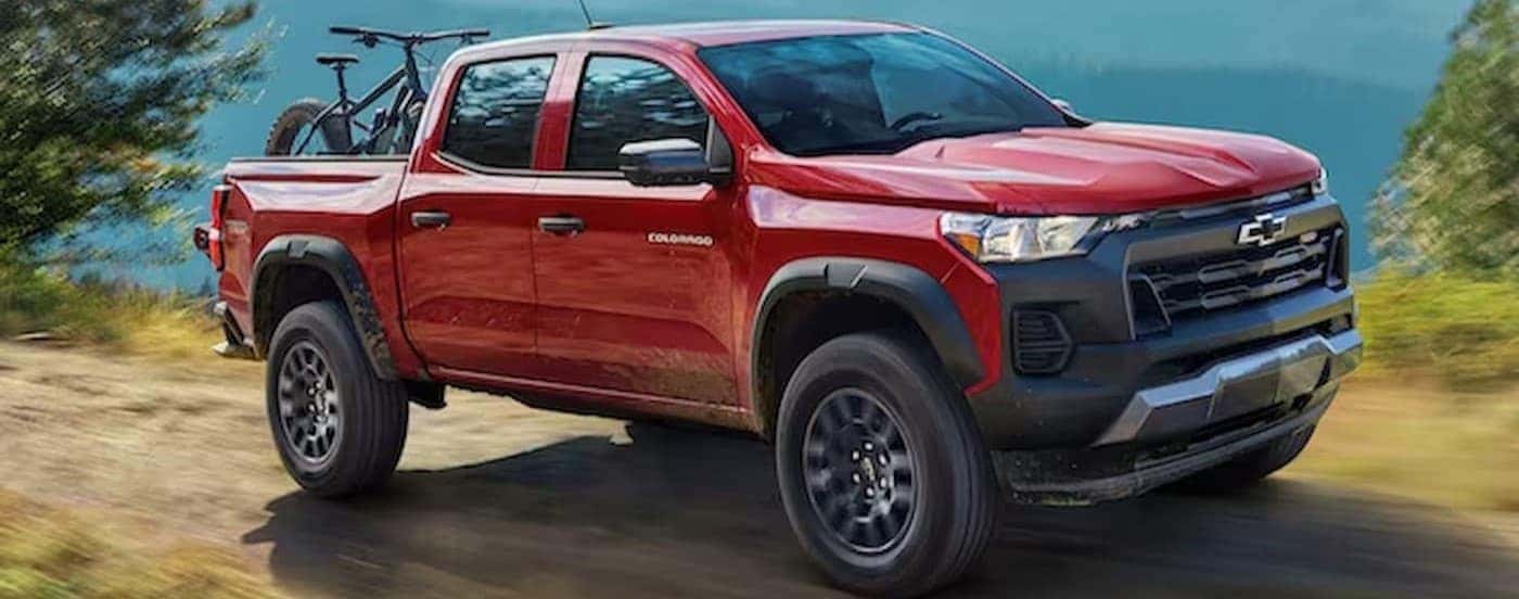 A red 2024 Chevy Colorado driving offroad.