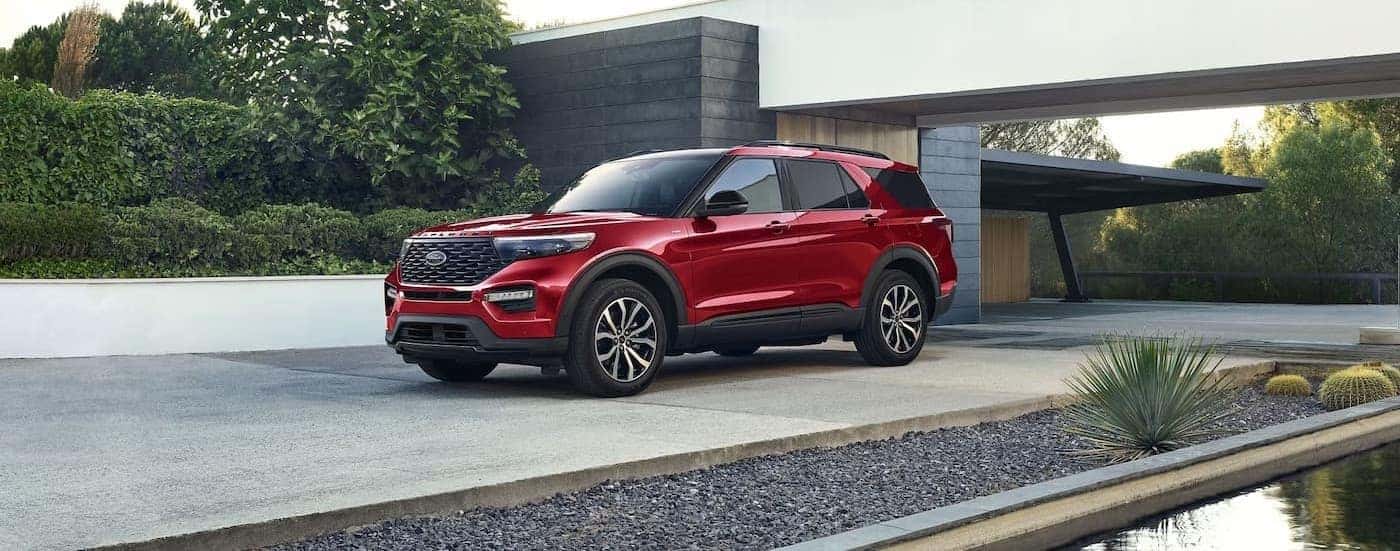 A red 2024 Ford Explorer parked on a driveway.