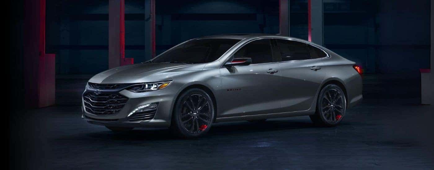 A gray 2024 Chevy Malibu Redline parked at night