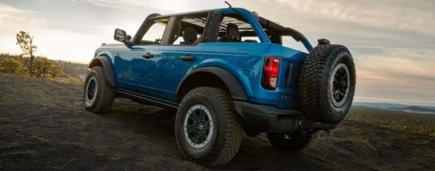 A blue 2025 Ford Bronco Sasquatch is shown from the rear at an angle.