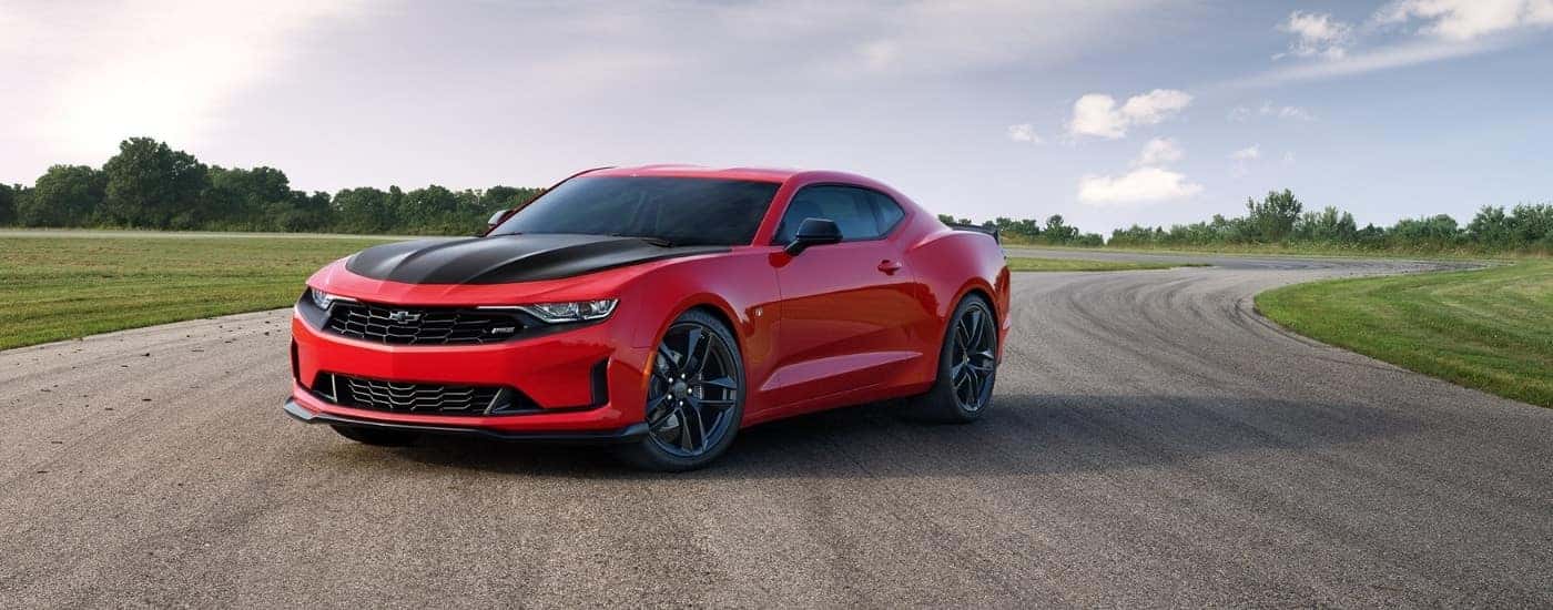 A red 2020 Chevy Camaro parked on a race track.