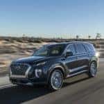 black suv driving down the road