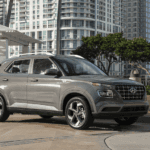2025 Hyundai Venue parked in an urban setting with modern high-rise buildings in the background.