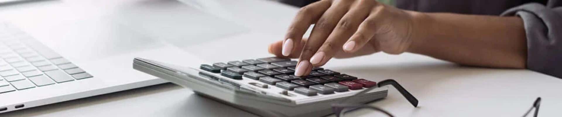Woman typing on a calculator