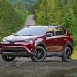 A red 2018 Toyota RAV4 is parked on a tree lined road near Indiana, PA.