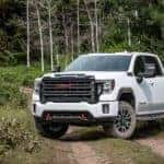 A white 2020 GMC Sierra HD is parked on a dirt trail outside Indiana, PA.
