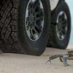 A closeup shows a crab in front of the wheels of a 2022 GMC Hummer EV, which will be coming to a GMC dealer in Indiana, PA.