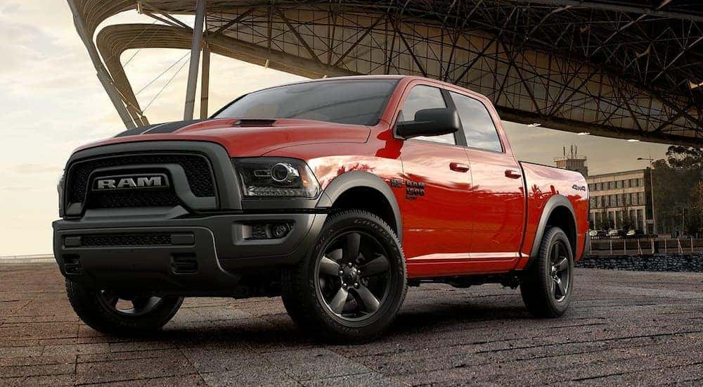 A red 2019 Ram 1500 Classic is parked in an airplane hanger.