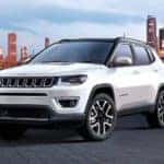 A white 2017 Jeep Compass is parked overlooking a city after leaving the used Jeep dealer in Lexington.