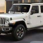 A white 2021 Jeep Wrangler is shown from a side angle after looking at new cars in stock near you.