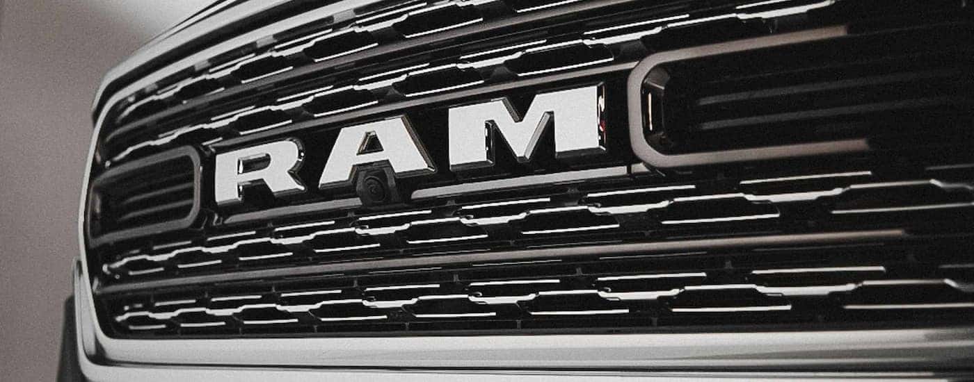A close up of the silver grille and badge on a 2022 Ram 1500.