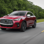 Dynamic Sunstone Red 2025 INFINITI QX55 traveling on road