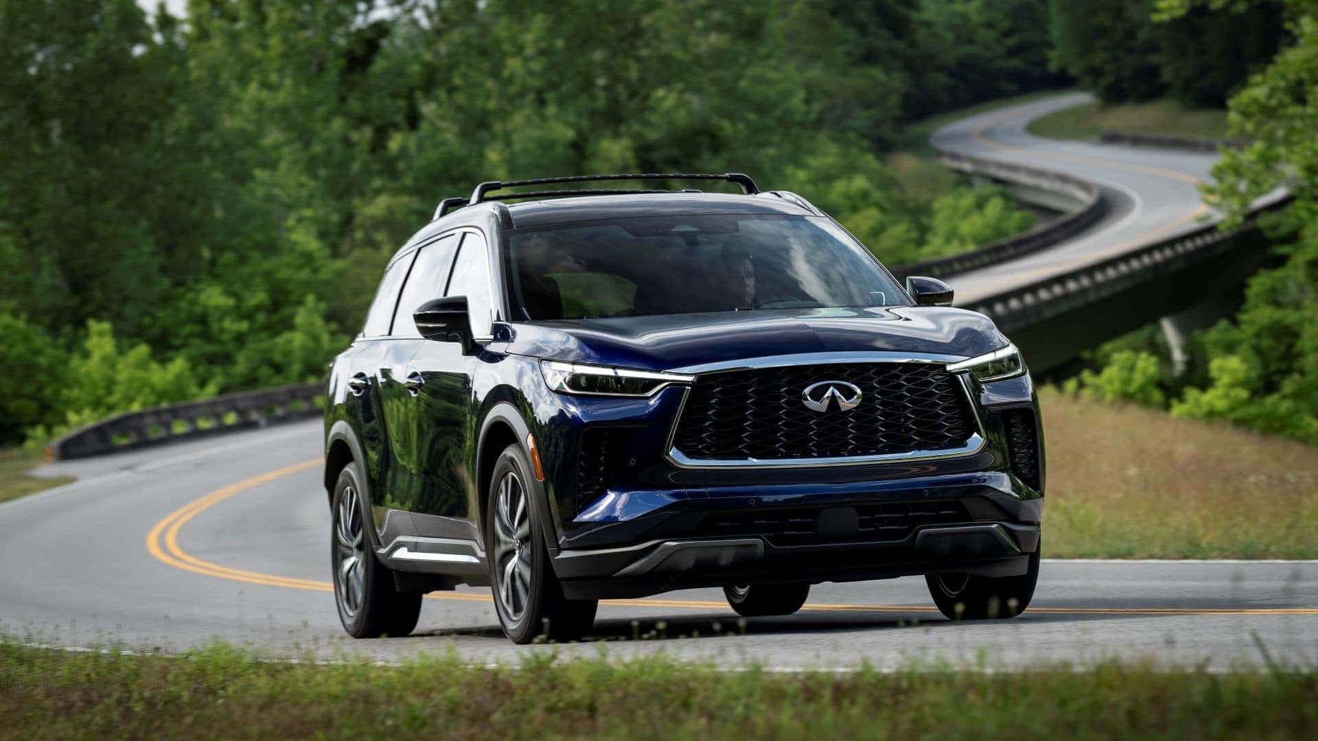 Grand Blue 2024 INFINITI QX60 with driver