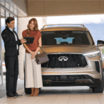 Gray INFINITI QX80 man and woman with tablet
