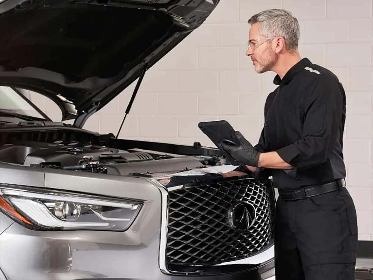 Grey INFINITI hood opened multi-point inspection