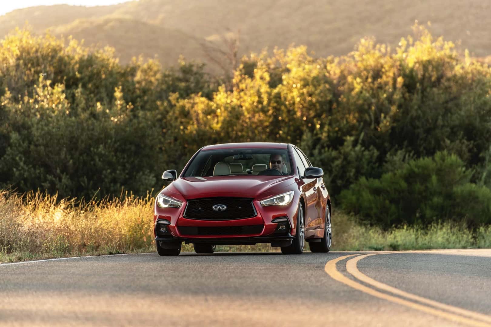 2023 INFINITI Q50 Dynamic Sunstone Red driving