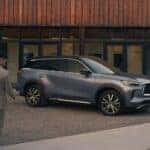 A INFINITI Driver Wirelessly Unlocking Their 2025 INFINITI QX60, Parked Glamorously