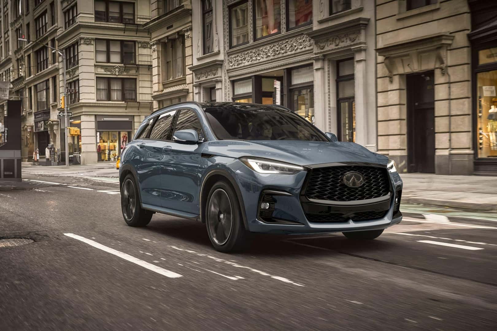 A Driver Cruising Urban Downtown In Her Dependable 2025 INFINITI QX50