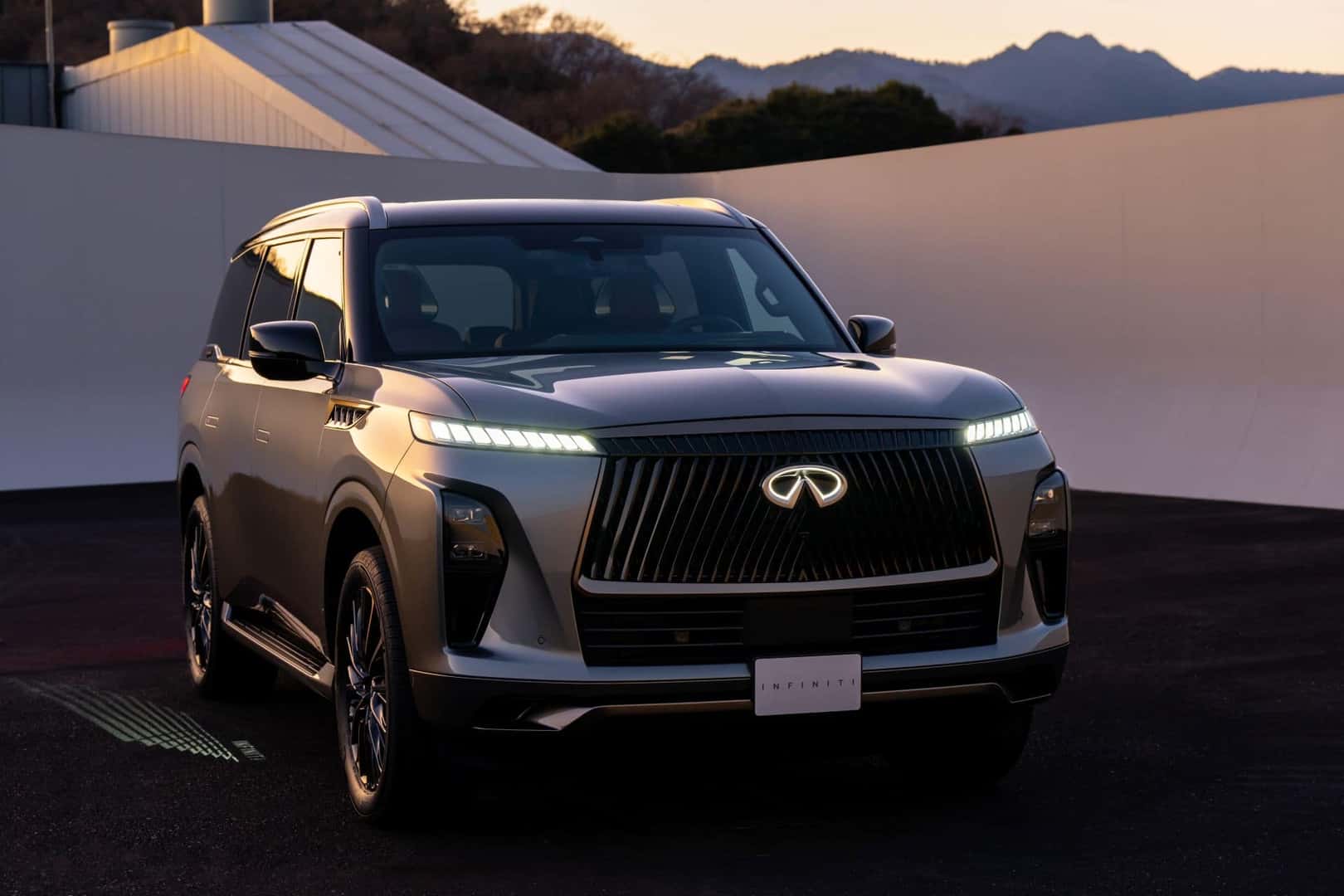 The Bright Headlights Of The Sleek And Advanced 2025 INFINITI QX80, Parked Majestically