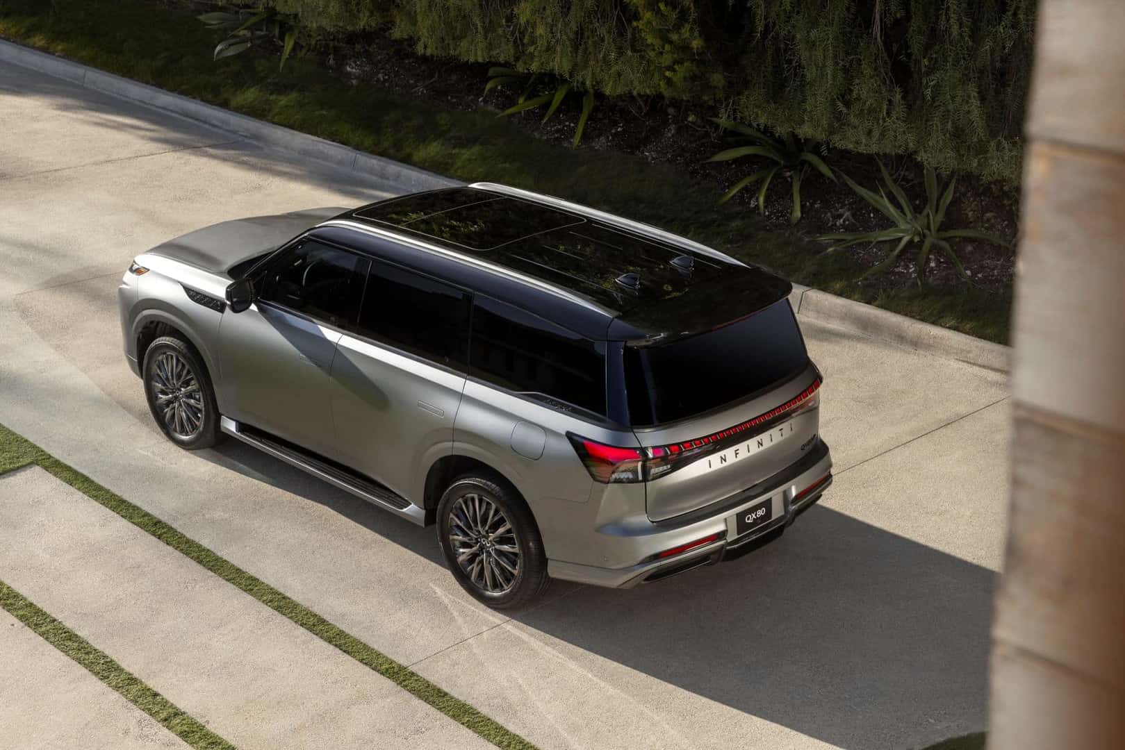 An Overhead Shot Of The Warmly Awarded 2025 INFINIT QX80, Driving Out Of A Smooth Driveway