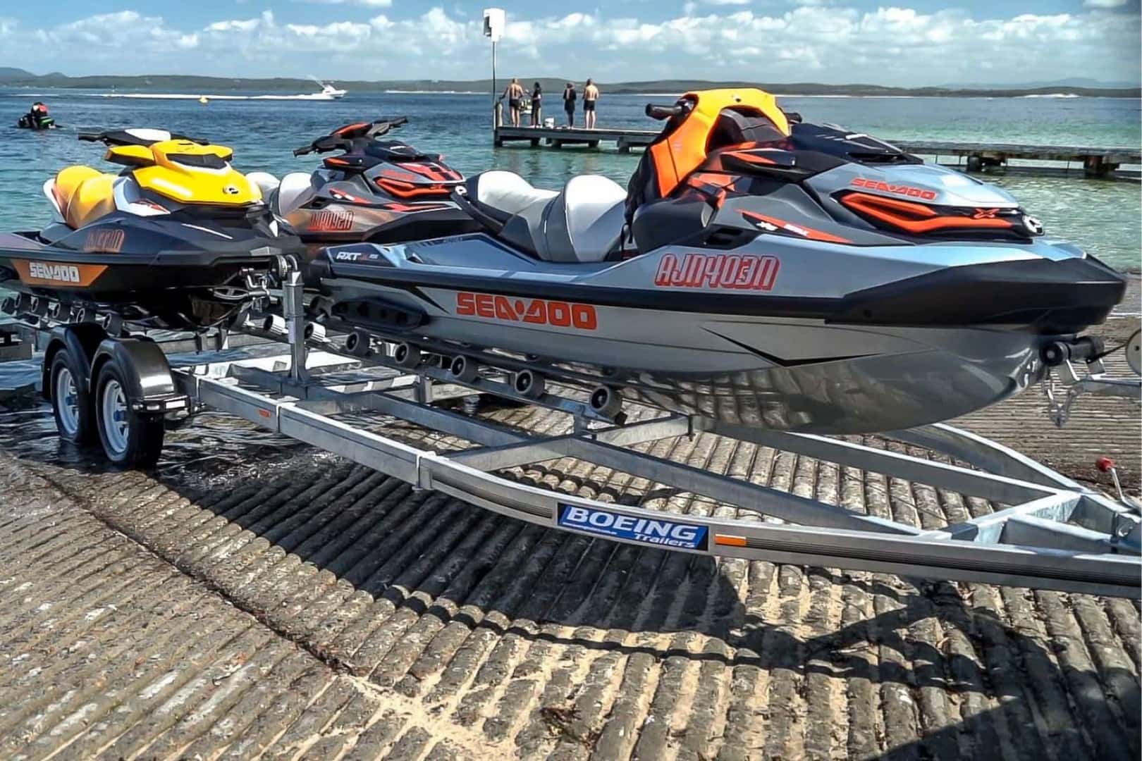 A Slim And Fine Boeing Triple Jet Ski On A Trailer, Attached To A Capable INFINITI