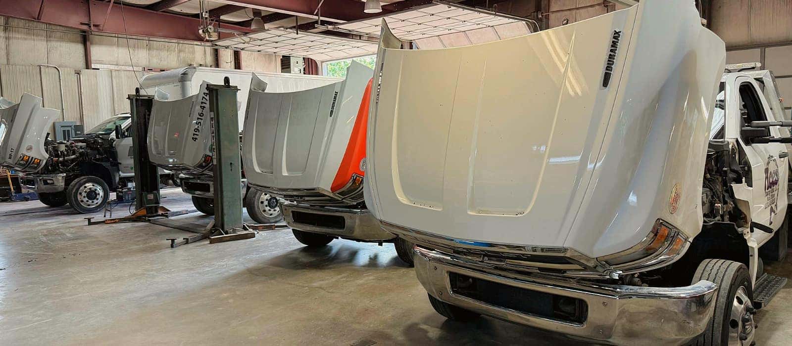 Medium-duty commercial fleet trucks being serviced at Evans Chevrolet GMC in Wapakoneta, Ohio