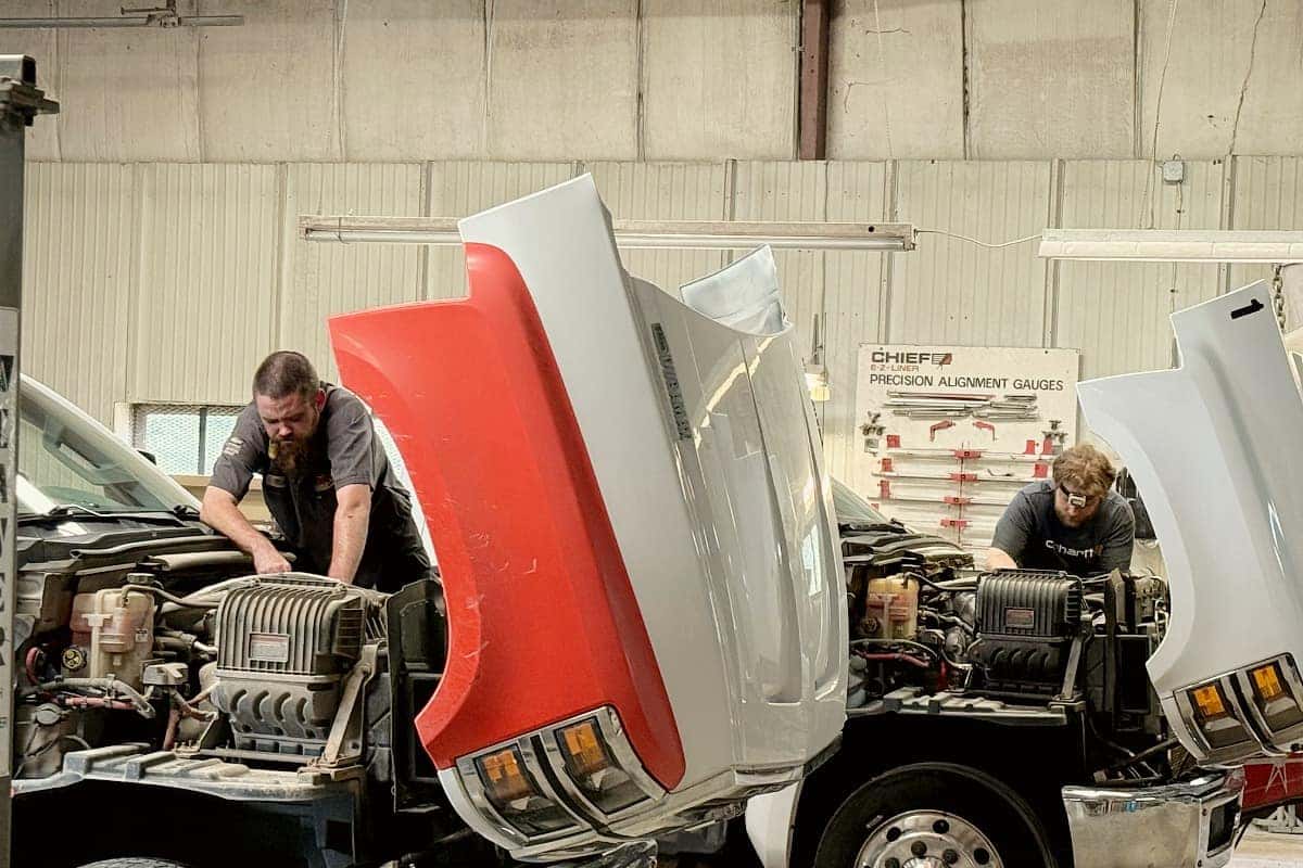 Factory-trained GM medium-duty diesel technician servicing a commercial truck at Evans Chevrolet GMC