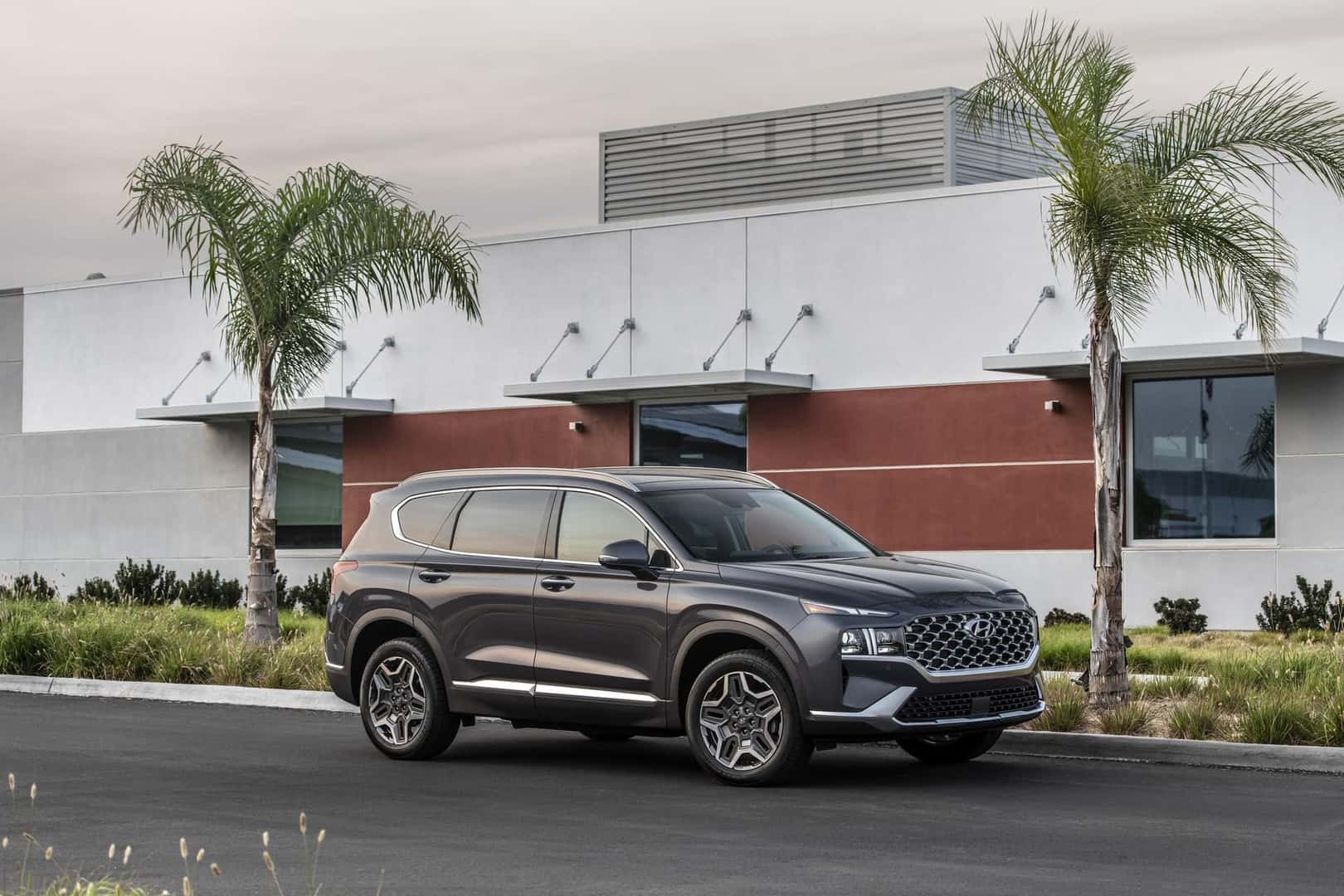 A 2023 Hyundai Santa Fe compact SUV displayed in various colors, showcasing its modern design and versatility.