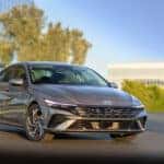 a sleek new 2025 Hyundai Elantra parked in front of glass building