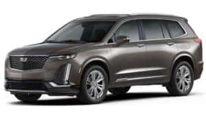 A brown 2020 Cadillac XT6 on white facing left