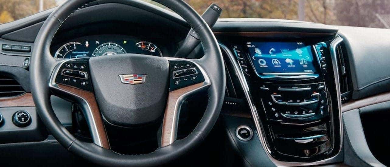 The steering wheel and infotainment center are shown in a 2020 Cadillac Escalade.
