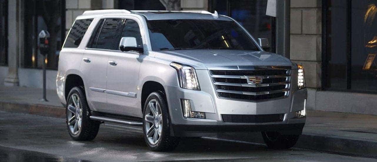 A silver 2020 Cadillac Escalade is parked on a city street after winning the 2020 Cadillac Escalade vs 2020 Lincoln Navigator comparison.